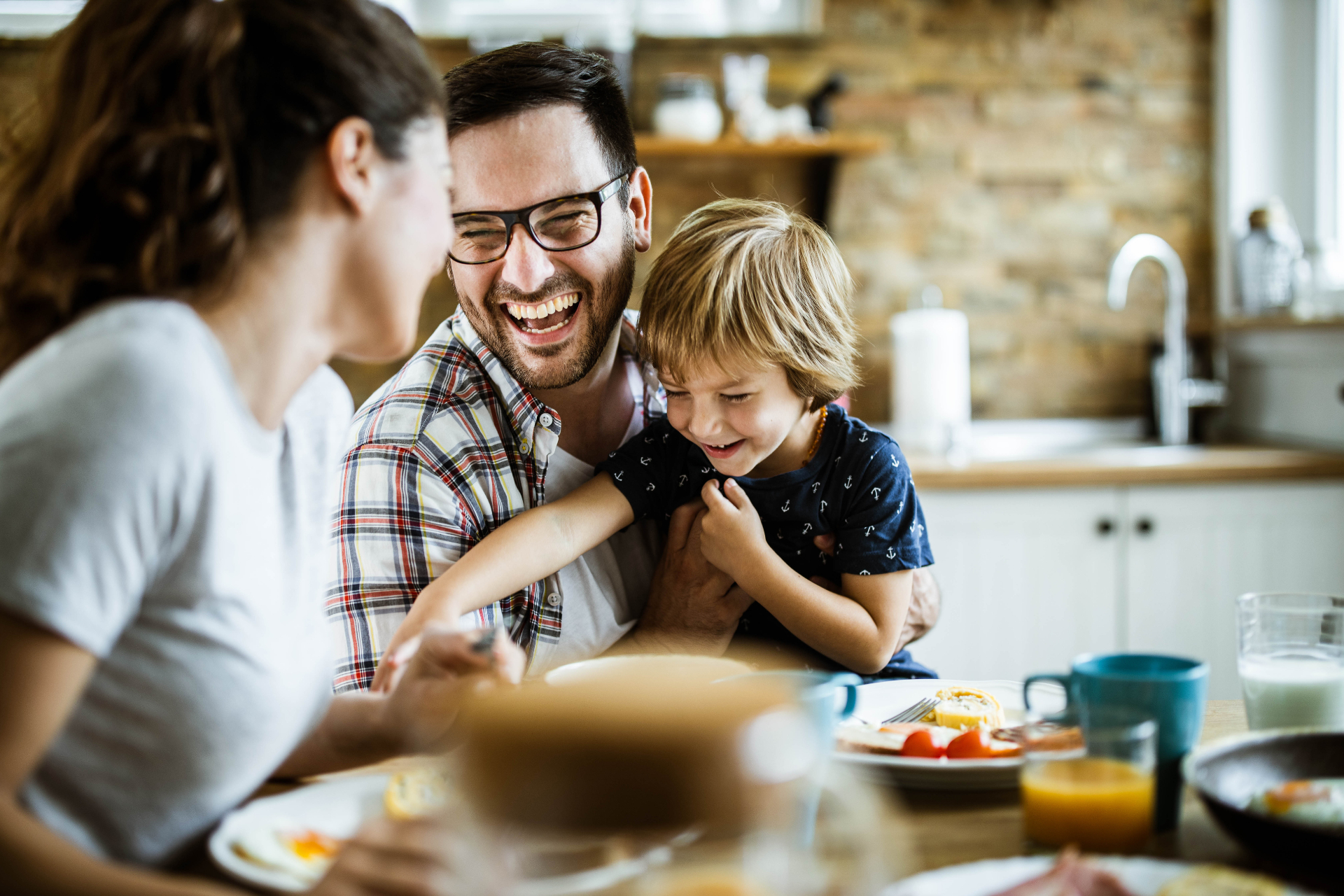 Family laughing at breakfast