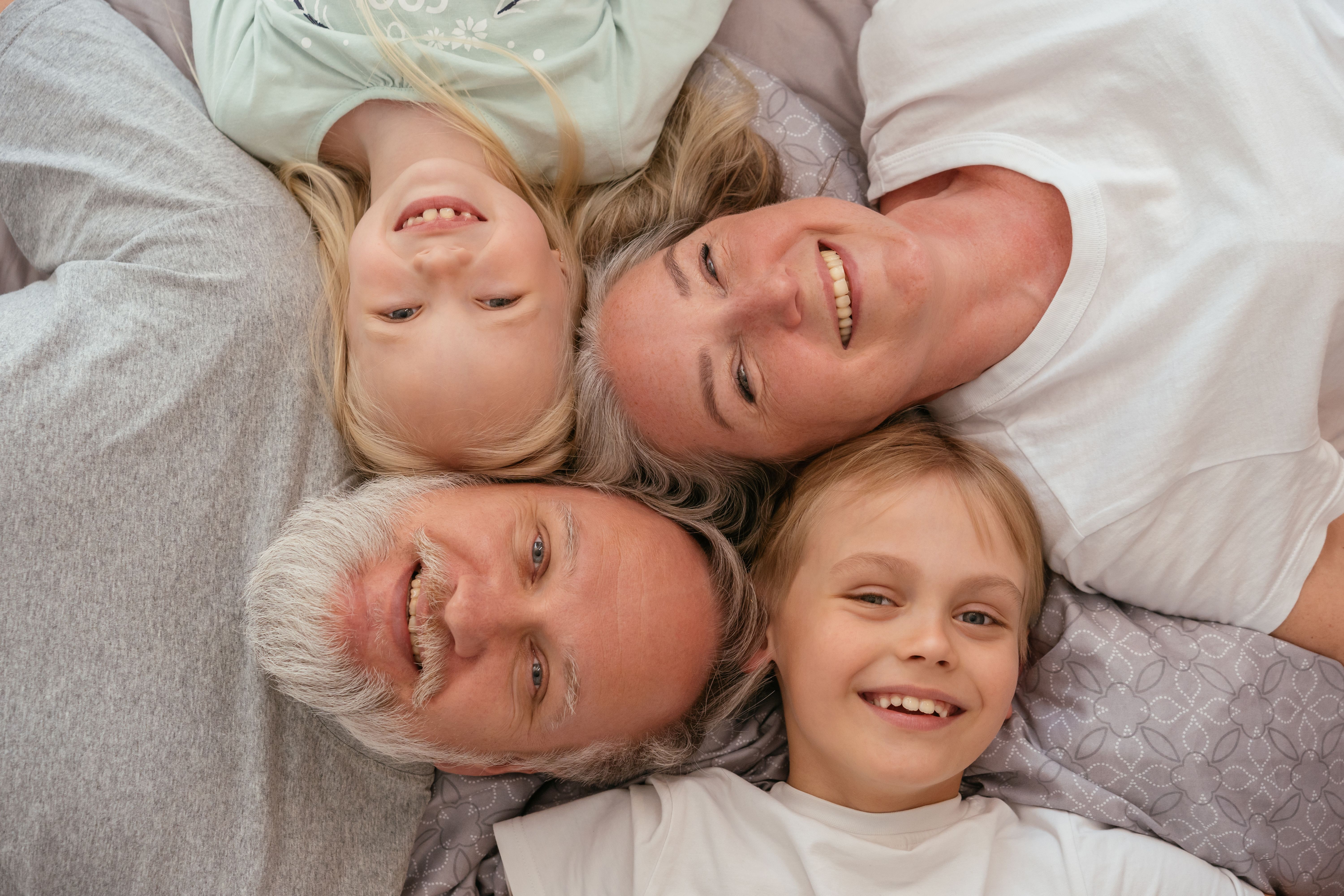 Grandparents and grandchildren smiling together.